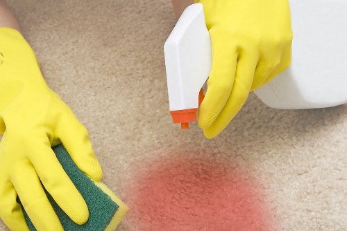 Professional oven cleaner in Kennington cleaning a greasy kitchen oven