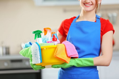 Cleaner following health and safety procedures in a professional setting