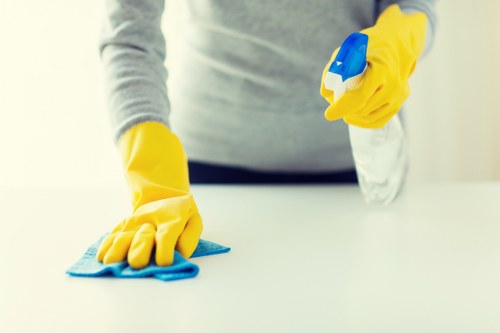 Cleaning staff using safe handling practices with protective equipment
